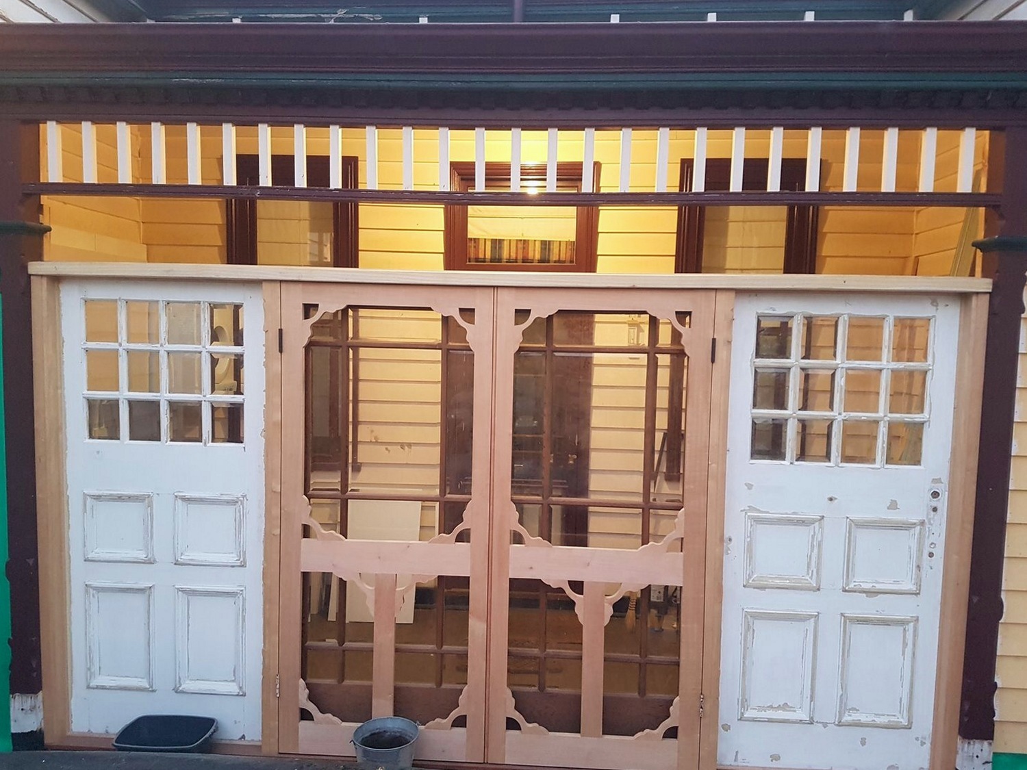 Custom screen doors and glazed doors to a rear entrance, finished