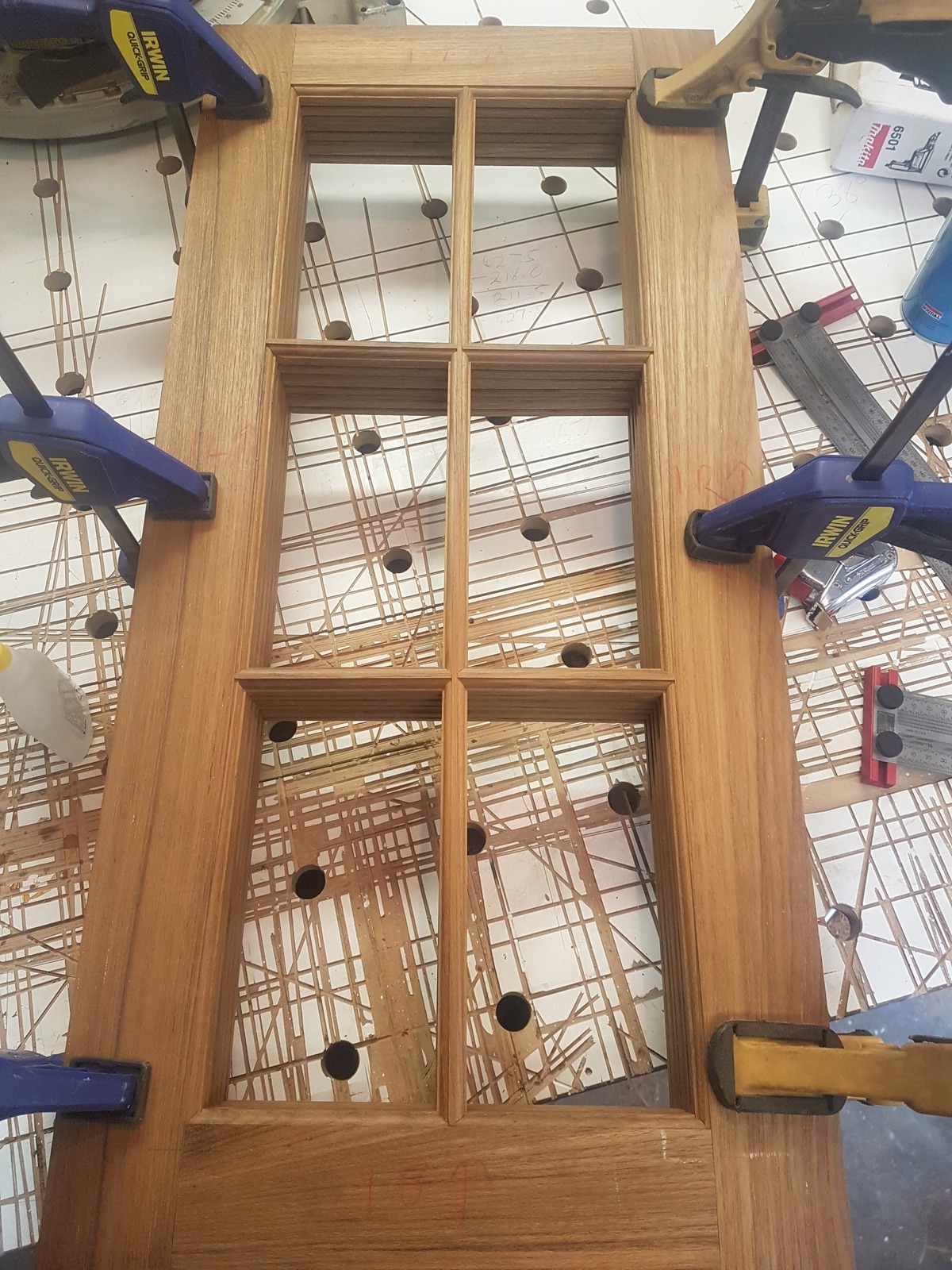 Divided-light cabinet doors clamped up in the workshop